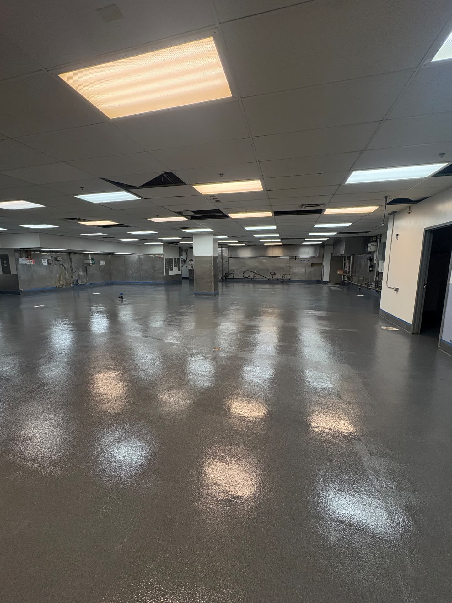 Commercial kitchen floor being prepped before the final coating